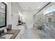 Bright bathroom featuring granite counters, a glass shower, and modern fixtures and design at 3911 Peeksville Rd, Locust Grove, GA 30248