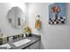 Well-lit bathroom featuring a granite countertop, decorative mirror, and stylish floral accents at 3911 Peeksville Rd, Locust Grove, GA 30248
