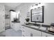 Bright bathroom featuring dual vanities, granite countertops, and modern fixtures in a spacious layout at 3911 Peeksville Rd, Locust Grove, GA 30248