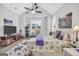 Serene bedroom with a vaulted ceiling, ceiling fan, a plush rug, and natural light from the windows at 3911 Peeksville Rd, Locust Grove, GA 30248