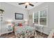 Bright bedroom with a decorative quilt, window view, and charming bedside tables at 3911 Peeksville Rd, Locust Grove, GA 30248