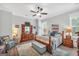 Cozy bedroom with a ceiling fan, a decorative dresser, and comfortable furnishings at 3911 Peeksville Rd, Locust Grove, GA 30248