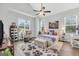 Cozy bedroom with vaulted ceilings, a ceiling fan, and a sitting area with a picturesque view at 3911 Peeksville Rd, Locust Grove, GA 30248