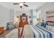 Comfortable bedroom with a ceiling fan, dresser, and a relaxing window view at 3911 Peeksville Rd, Locust Grove, GA 30248