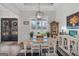 Dining room featuring a white table and chairs, decorative accents, and open access to the foyer at 3911 Peeksville Rd, Locust Grove, GA 30248