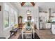 Bright dining area features wood beams, large windows, and a view into the kitchen at 3911 Peeksville Rd, Locust Grove, GA 30248