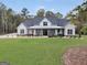 Lovely two-story home boasts a cozy front porch, verdant lawn, and tasteful landscaping at 3911 Peeksville Rd, Locust Grove, GA 30248