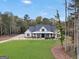 Inviting home featuring a covered porch, well-manicured lawn, and mature trees providing privacy at 3911 Peeksville Rd, Locust Grove, GA 30248