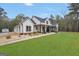 Charming single-story home featuring a covered front porch, well-manicured lawn, and neutral color palette at 3911 Peeksville Rd, Locust Grove, GA 30248