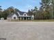 Beautiful exterior view of a modern farmhouse with a covered porch and manicured landscaping in a rural setting at 3911 Peeksville Rd, Locust Grove, GA 30248