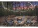 Cozy fire pit area with seating, perfect for outdoor entertaining with string lights at 3911 Peeksville Rd, Locust Grove, GA 30248
