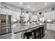 Spacious kitchen with a large island, modern stainless steel appliances, and designer lighting at 3911 Peeksville Rd, Locust Grove, GA 30248