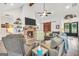 Inviting living room featuring brick fireplace, vaulted ceilings, and comfortable seating at 3911 Peeksville Rd, Locust Grove, GA 30248