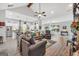 Living room featuring gray couches, vaulted ceiling, and view to kitchen at 3911 Peeksville Rd, Locust Grove, GA 30248