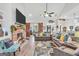 Bright living room with gray couches, a brick fireplace, and a view to the dining area at 3911 Peeksville Rd, Locust Grove, GA 30248