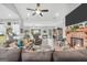 Bright living room with gray couches, vaulted ceilings, and brick fireplace at 3911 Peeksville Rd, Locust Grove, GA 30248