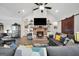 Comfortable living room with brick fireplace, ceiling fan, and gray couches at 3911 Peeksville Rd, Locust Grove, GA 30248