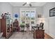 Inviting office space with a large window, classic wooden desk, and ample display shelving at 3911 Peeksville Rd, Locust Grove, GA 30248