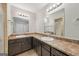 Bathroom featuring double sinks, mirrors, and dark cabinetry at 5362 Kelleys Mill Cir, Stone Mountain, GA 30088