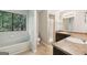 Bathroom features a tub, shower, and dark cabinets at 5362 Kelleys Mill Cir, Stone Mountain, GA 30088