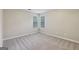 A simple bedroom with neutral carpet, two windows, and ample space for furnishings at 5362 Kelleys Mill Cir, Stone Mountain, GA 30088