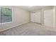A carpeted bedroom features a large window and a double door closet at 5362 Kelleys Mill Cir, Stone Mountain, GA 30088