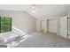 Bedroom featuring a carpeted floor, ceiling fan, and walk in closet at 5362 Kelleys Mill Cir, Stone Mountain, GA 30088