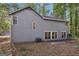 Exterior of home featuring light gray siding and glass doors at 5362 Kelleys Mill Cir, Stone Mountain, GA 30088