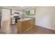 This kitchen offers functionality and space with a breakfast bar and durable laminate flooring at 5362 Kelleys Mill Cir, Stone Mountain, GA 30088