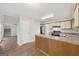 Kitchen with laminate flooring, breakfast bar, white cabinets, and updated black appliances at 5362 Kelleys Mill Cir, Stone Mountain, GA 30088