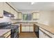 A functional kitchen features a gas range, ample cabinet space, and a window over the sink at 5362 Kelleys Mill Cir, Stone Mountain, GA 30088
