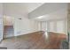 Spacious living room with wood flooring, stairs, and a view of the backyard through sliding glass doors at 5362 Kelleys Mill Cir, Stone Mountain, GA 30088