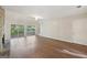 Bright living room with wood flooring, stone fireplace, and sliding glass doors to the backyard at 5362 Kelleys Mill Cir, Stone Mountain, GA 30088