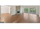 Spacious living room featuring wood flooring, a stone fireplace, and sliding glass doors to the backyard at 5362 Kelleys Mill Cir, Stone Mountain, GA 30088