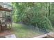 Spacious backyard with a wooden deck and lush green foliage and a chain link fence at 714 Yates Rd, Bowdon, GA 30108