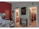 Bedroom with en-suite bathroom and walk-in closet, featuring a decorative headboard and accent wall at 714 Yates Rd, Bowdon, GA 30108