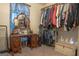 Walk-in closet featuring a vanity, mirror, and organized storage space for clothes and personal items at 714 Yates Rd, Bowdon, GA 30108