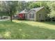 Exterior view of house with a large lawn, trees, and charming front porch at 714 Yates Rd, Bowdon, GA 30108