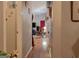 Hallway with hardwood floors leading to a living area featuring a TV, rocking chair, and natural light at 714 Yates Rd, Bowdon, GA 30108