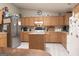 Spacious kitchen featuring stainless steel refrigerator, wood cabinets, and a kitchen island at 714 Yates Rd, Bowdon, GA 30108