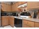 Well-equipped kitchen with wood cabinets, modern appliances, and ample counter space at 714 Yates Rd, Bowdon, GA 30108
