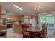 Cozy kitchen featuring wooden cabinets, dining area, and sliding glass doors to the backyard at 714 Yates Rd, Bowdon, GA 30108