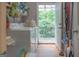 Bright laundry room with washer, dryer, and access to the backyard deck at 714 Yates Rd, Bowdon, GA 30108