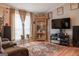 Comfortable living room featuring wood floors, neutral walls, and large windows at 714 Yates Rd, Bowdon, GA 30108