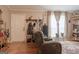 Cozy living room showing entryway with coat rack, recliner sofa, and wood floors at 714 Yates Rd, Bowdon, GA 30108