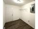 Unfinished basement featuring dark wood-look flooring, white walls, and a utility panel at 4049 Brookcrest Cir, Decatur, GA 30032