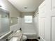 Bright bathroom with tiled walls, vinyl floors, and updated vanity at 4049 Brookcrest Cir, Decatur, GA 30032