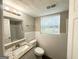 Bright bathroom with tiled walls, vinyl floors, and updated vanity at 4049 Brookcrest Cir, Decatur, GA 30032