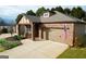Charming single-story brick home featuring an attached two-car garage and an inviting covered front porch at 511 Bonneset Ct, Canton, GA 30114