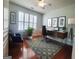 Bright home office with a modern desk, hardwood floors, and a comfortable sitting area bathed in natural light at 511 Bonneset Ct, Canton, GA 30114